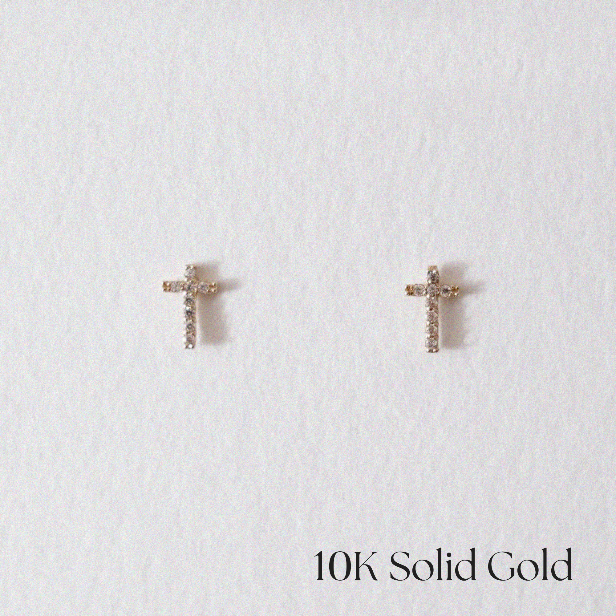Front view of 10K Crystal Cross Studs with CZ accents in polished gold