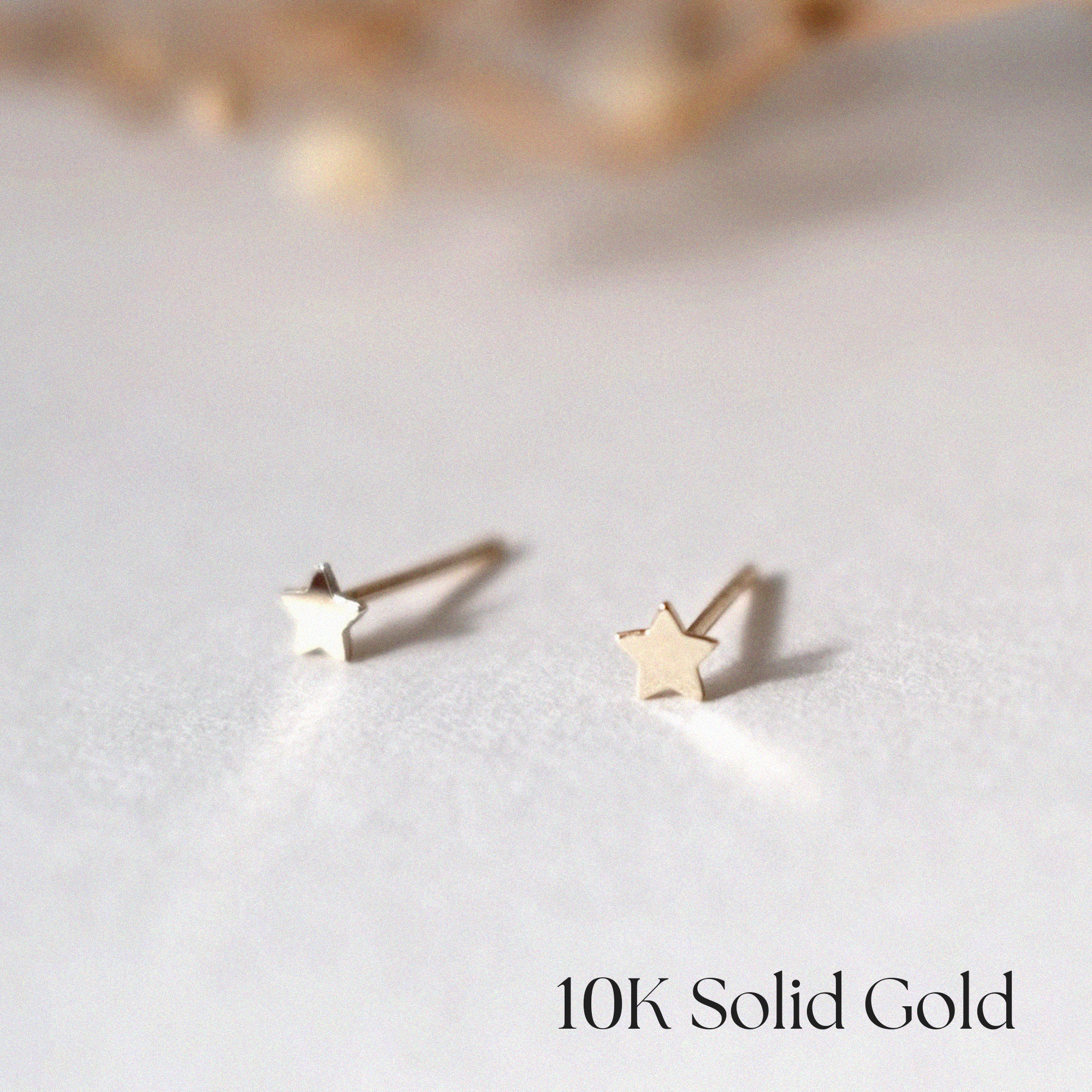 Side profile of 10K Petite Star Studs highlighting slim and dainty structure