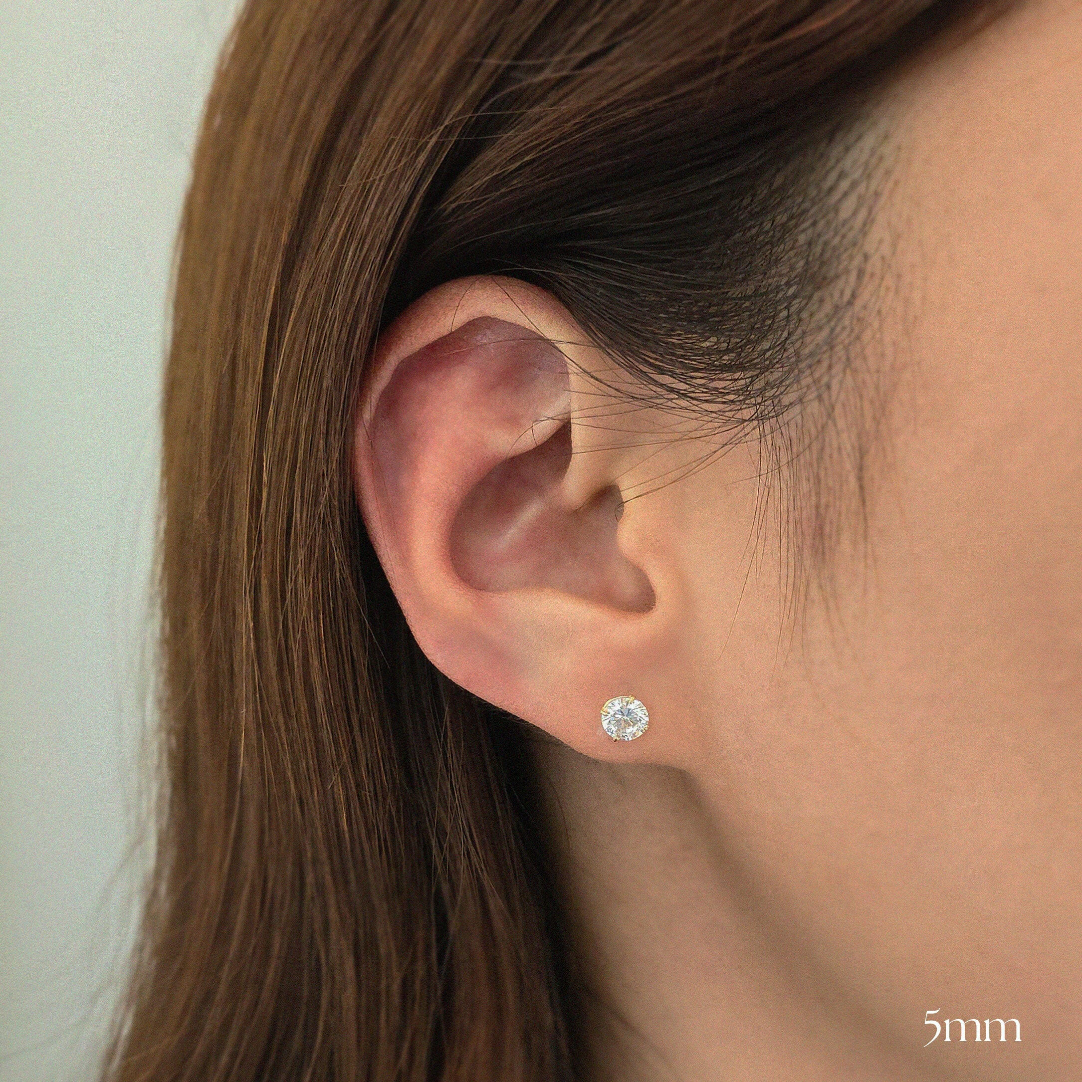 Model wearing 5mm crystal stud earrings for a minimal and chic look.