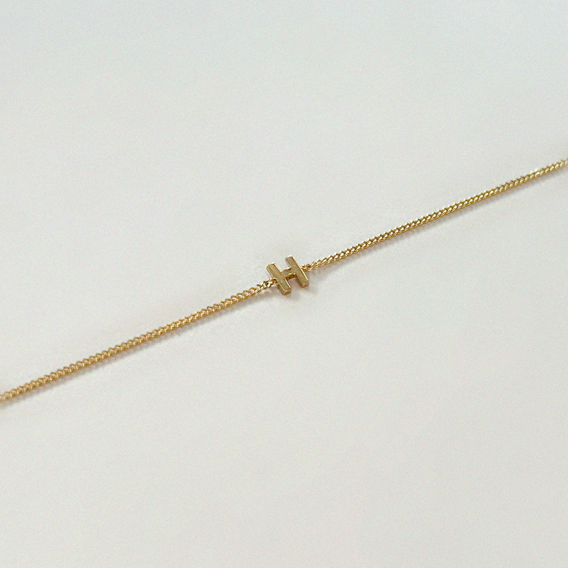 Custom initial bracelet with 14K gold chain and pendant styled flat