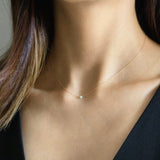 Model wearing the Aria Pearl Necklace with minimalist outfit, pendant sitting just above the collarbone
