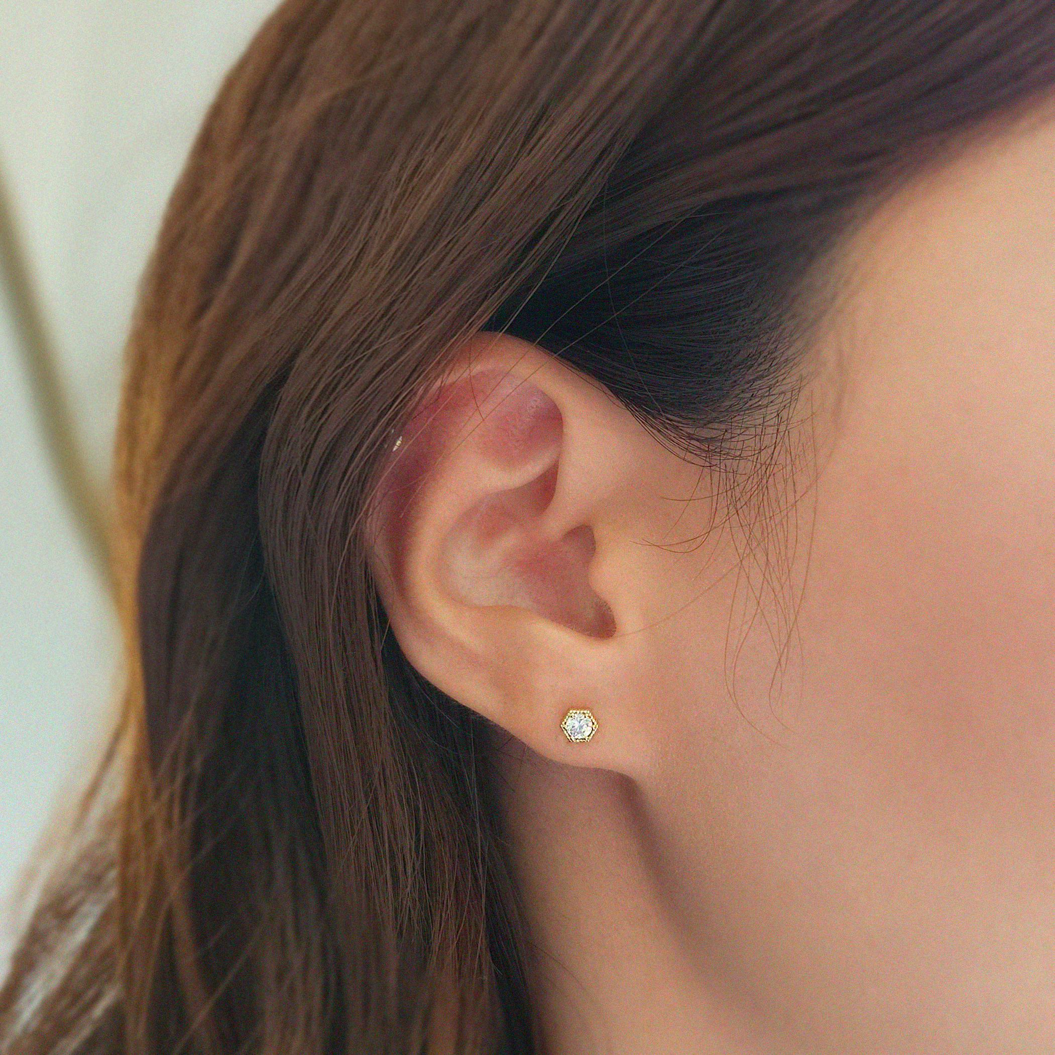 Gold hexagon studs styled solo for modern look