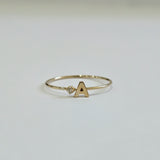 Front view of 14K Initial Ring with diamond accent and polished gold finish
