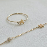 Angled view of 14K ring with clean letter design and subtle shine