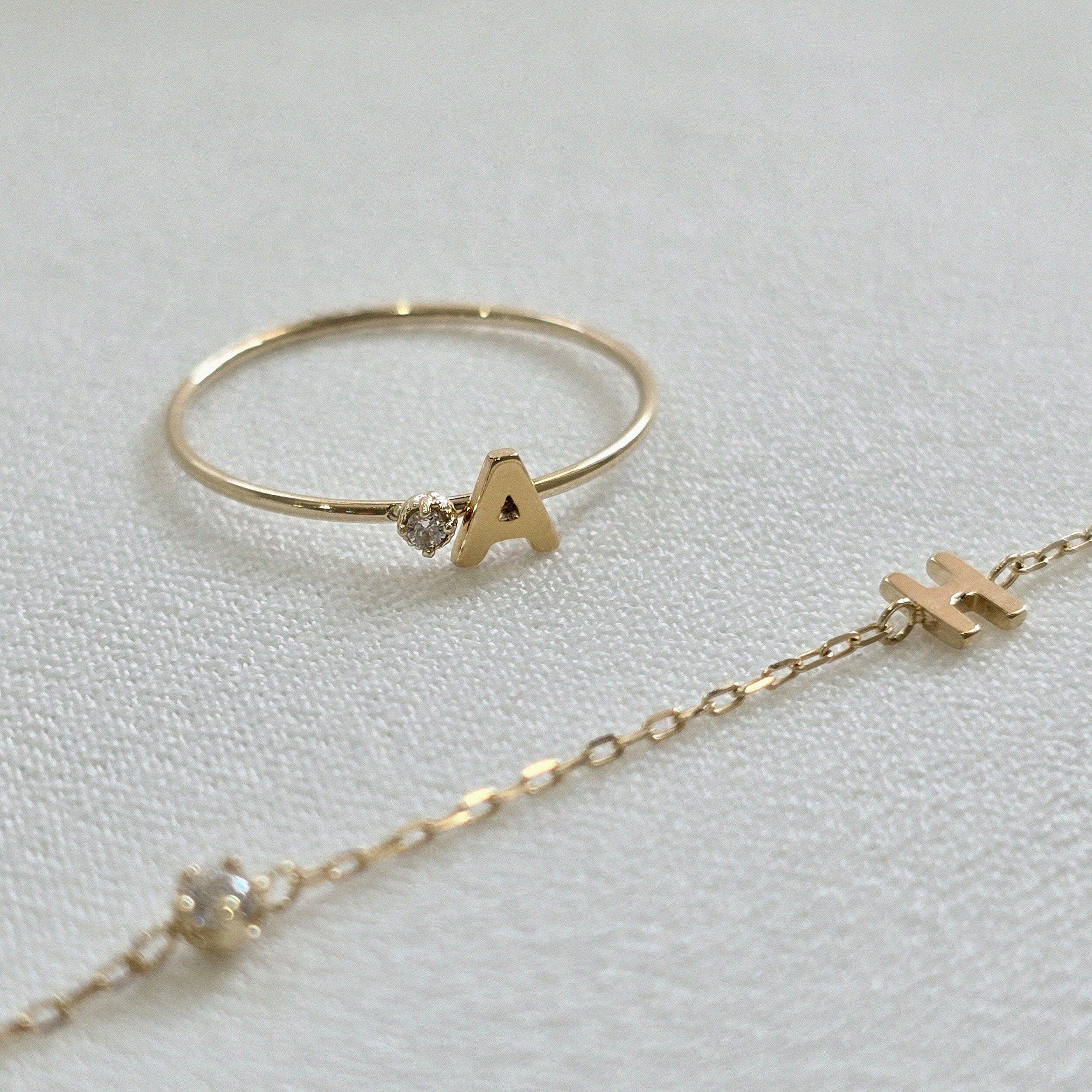 Angled view of 14K ring with clean letter design and subtle shine