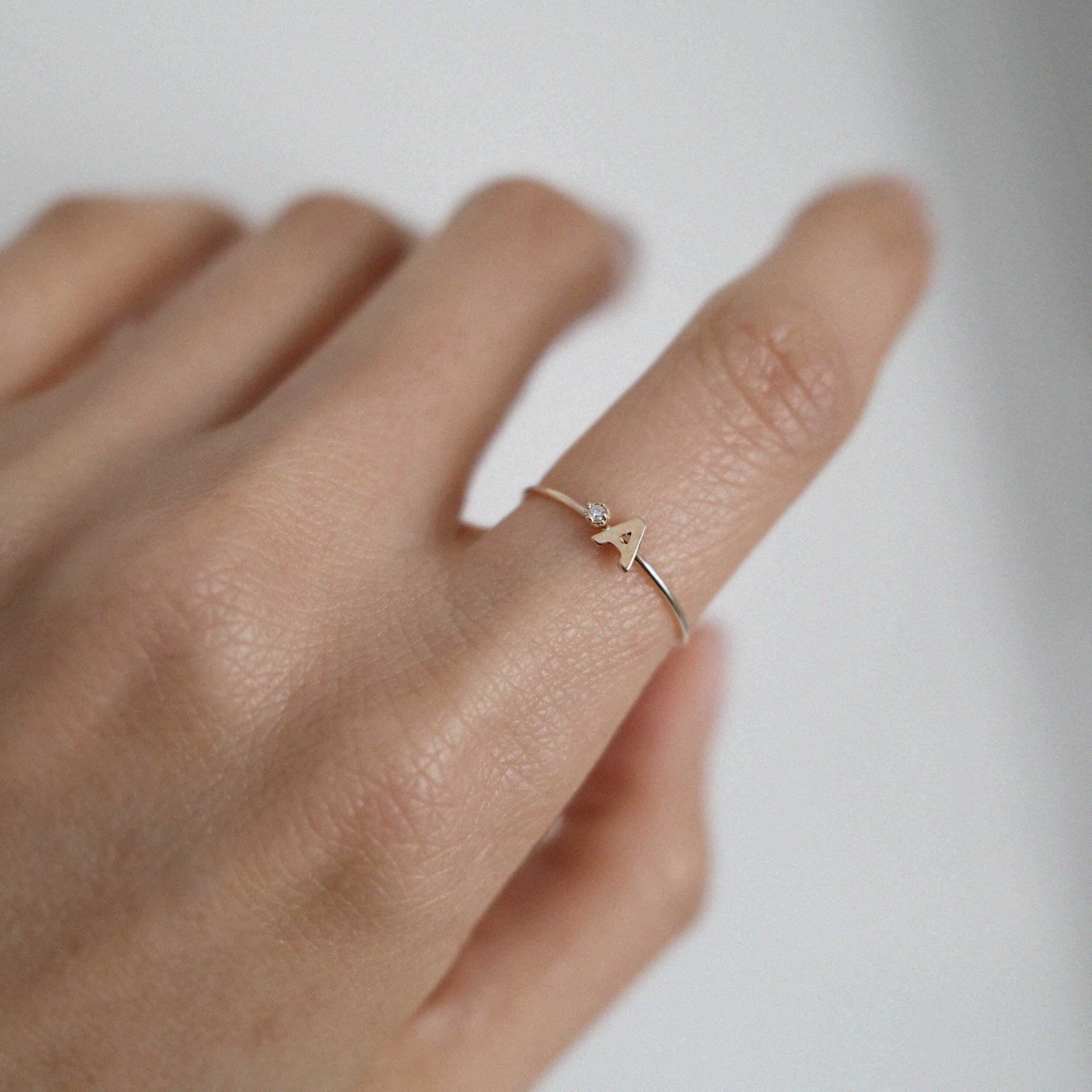Personalized gold initial ring worn alone for a delicate, signature look