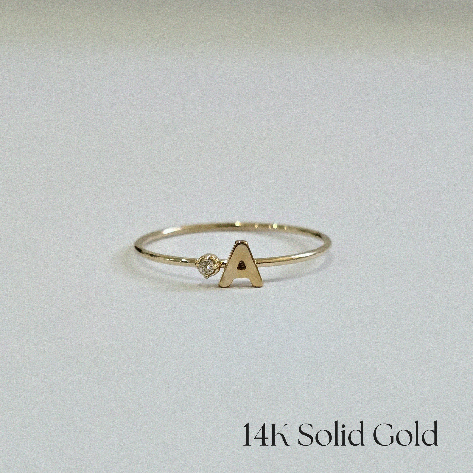 Front view of 14K Initial Ring with diamond accent and polished gold finish