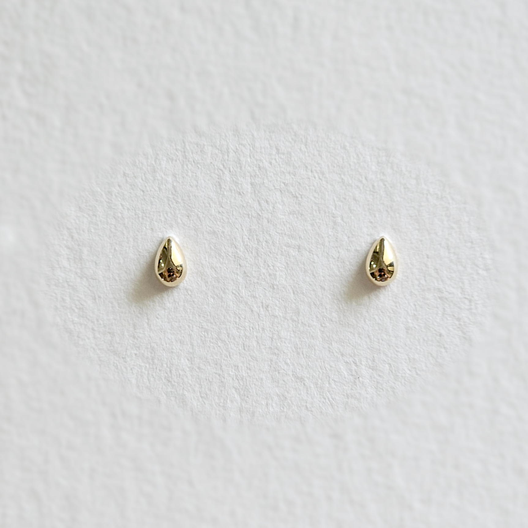 Front view of Petite Teardrop earrings in 14K yellow gold