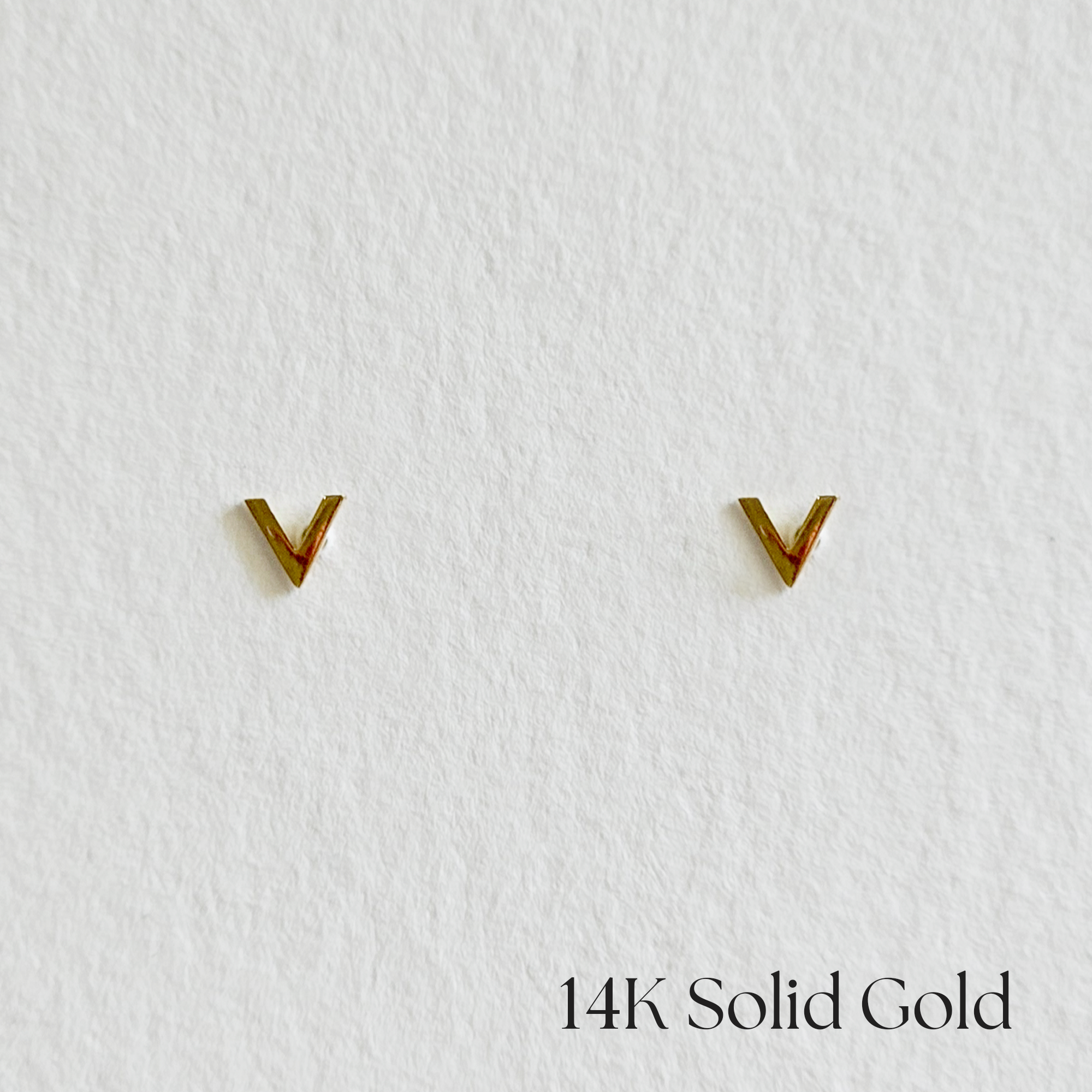Minimalist Petite V gold studs shown from front angle
