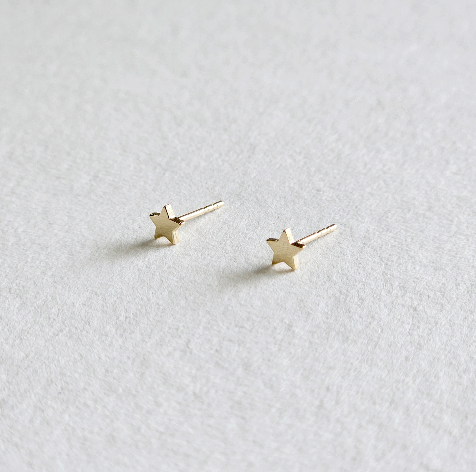 Side profile showing raised edges of gold star-shaped studs