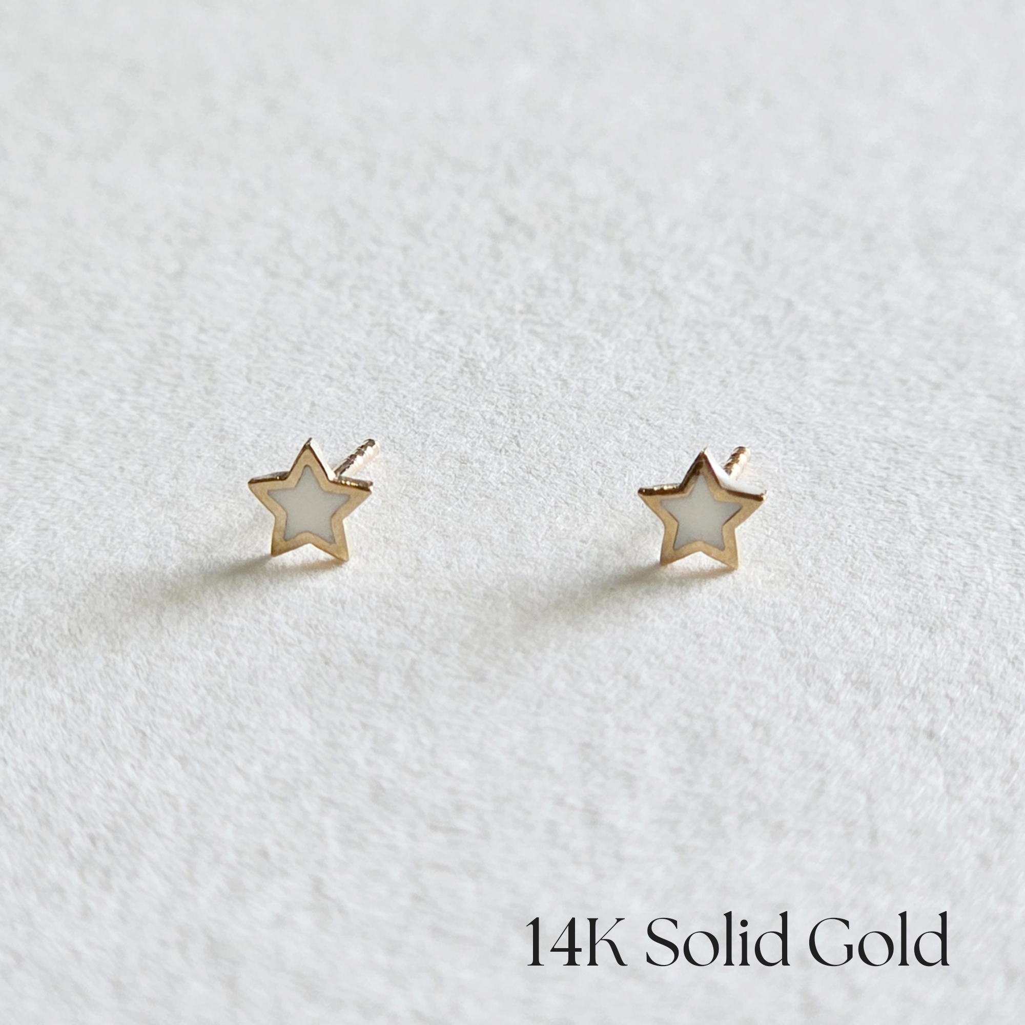 Front view of White Tiny Star Studs in polished 14K gold