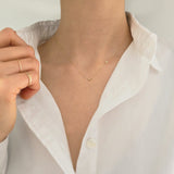 Model wearing Laondrim 14K initial necklace – dainty gold chain with diamond charm