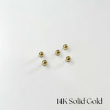 Multiple 14K gold screwball backs on white background