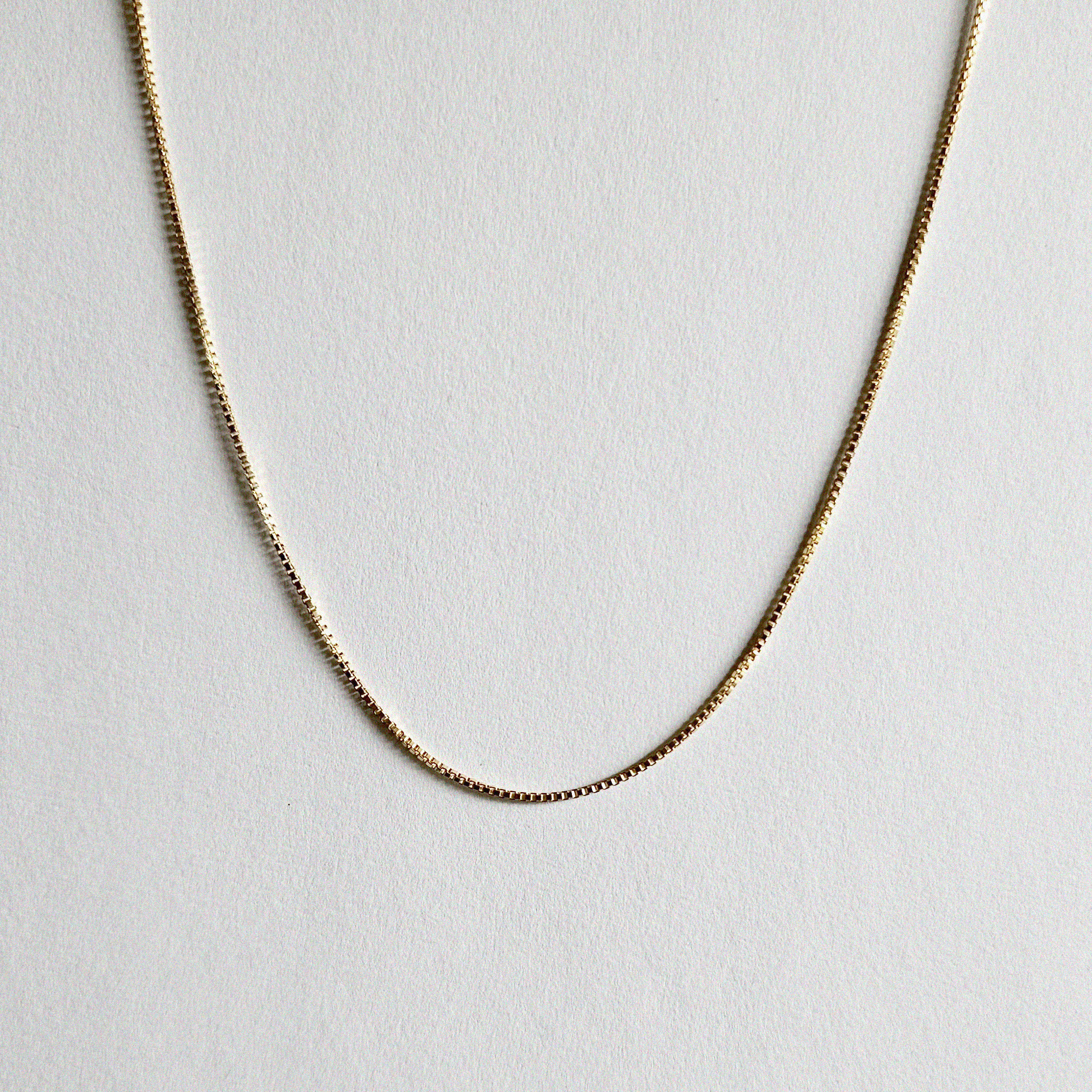 Box chain necklace laid flat with uniform square links