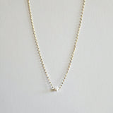 Single pearl necklace exemplifying elegant minimalism, perfect for timeless and sophisticated style.