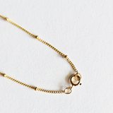 Side angle showing spring ring clasp and chain texture