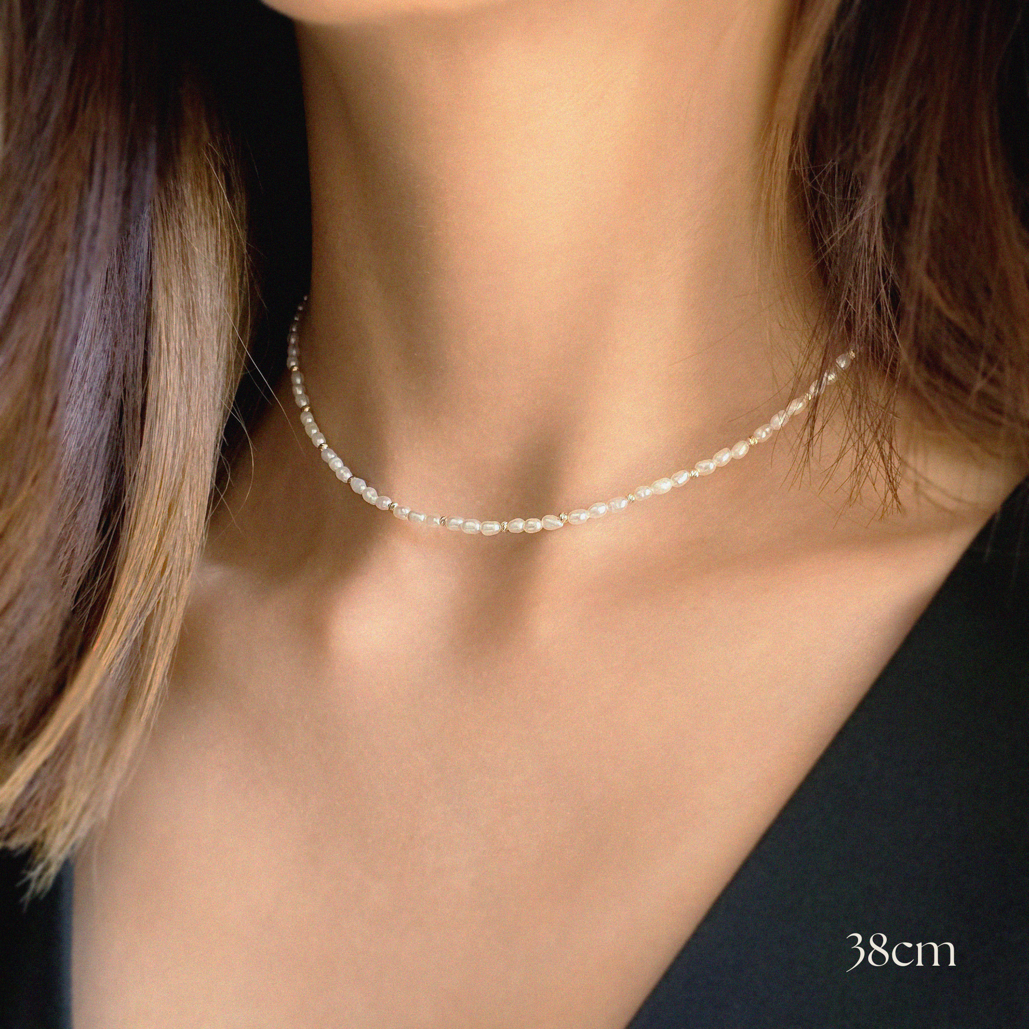 Close-up shot of Seed Pearl Necklace against bare neck