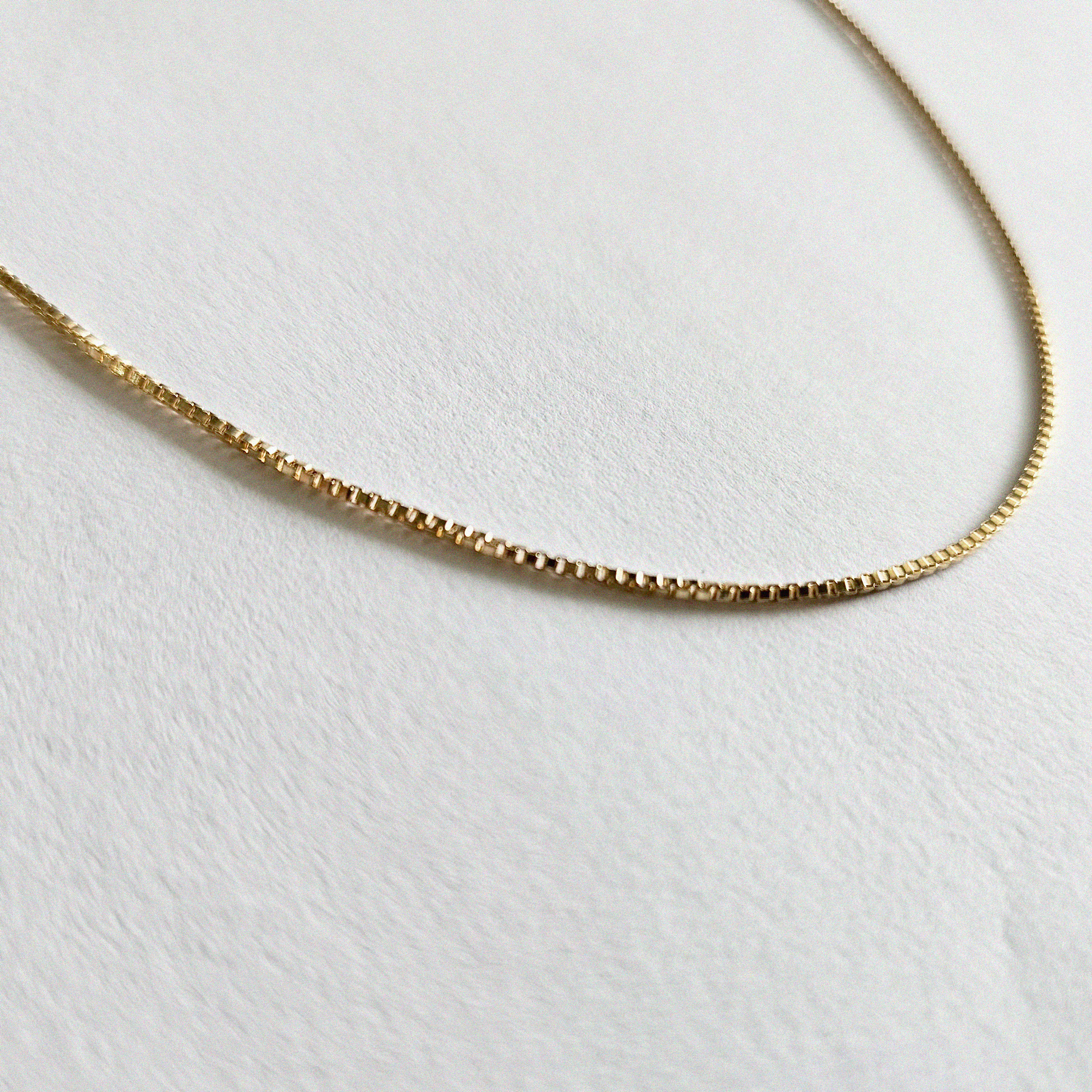 Box chain necklace laid flat with uniform square links