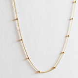 Close-up of gold filled dot detail with light reflection