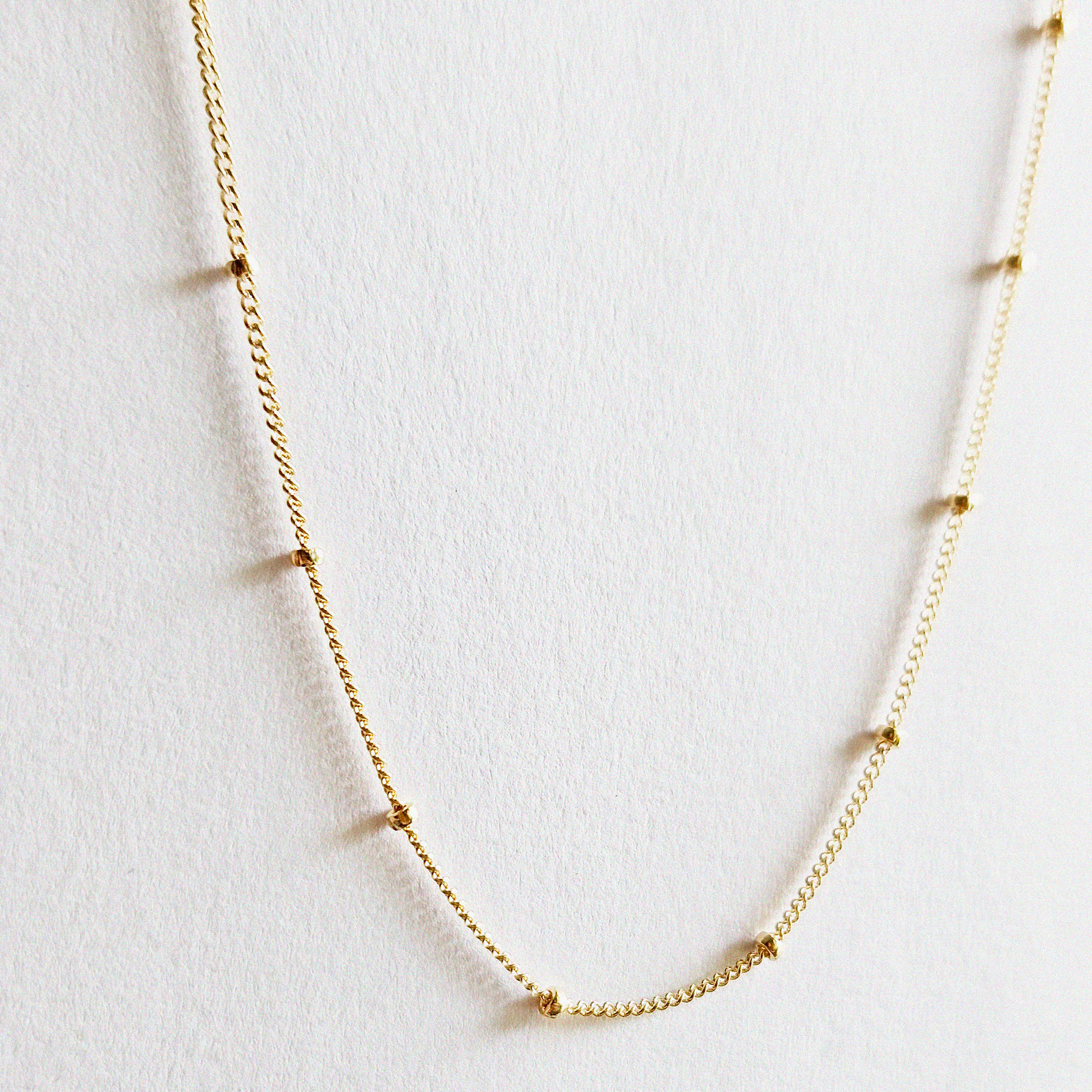 Close-up of gold filled dot detail with light reflection
