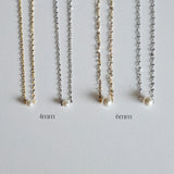 Single pearl necklace exemplifying elegant minimalism, perfect for timeless and sophisticated style.