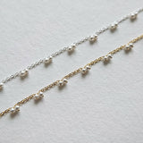 Petite pearl bracelet featuring a pair of lustrous small pearls artfully entwined for elegant style
