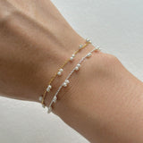 Petite pearl bracelet featuring a pair of lustrous small pearls artfully entwined for elegant style