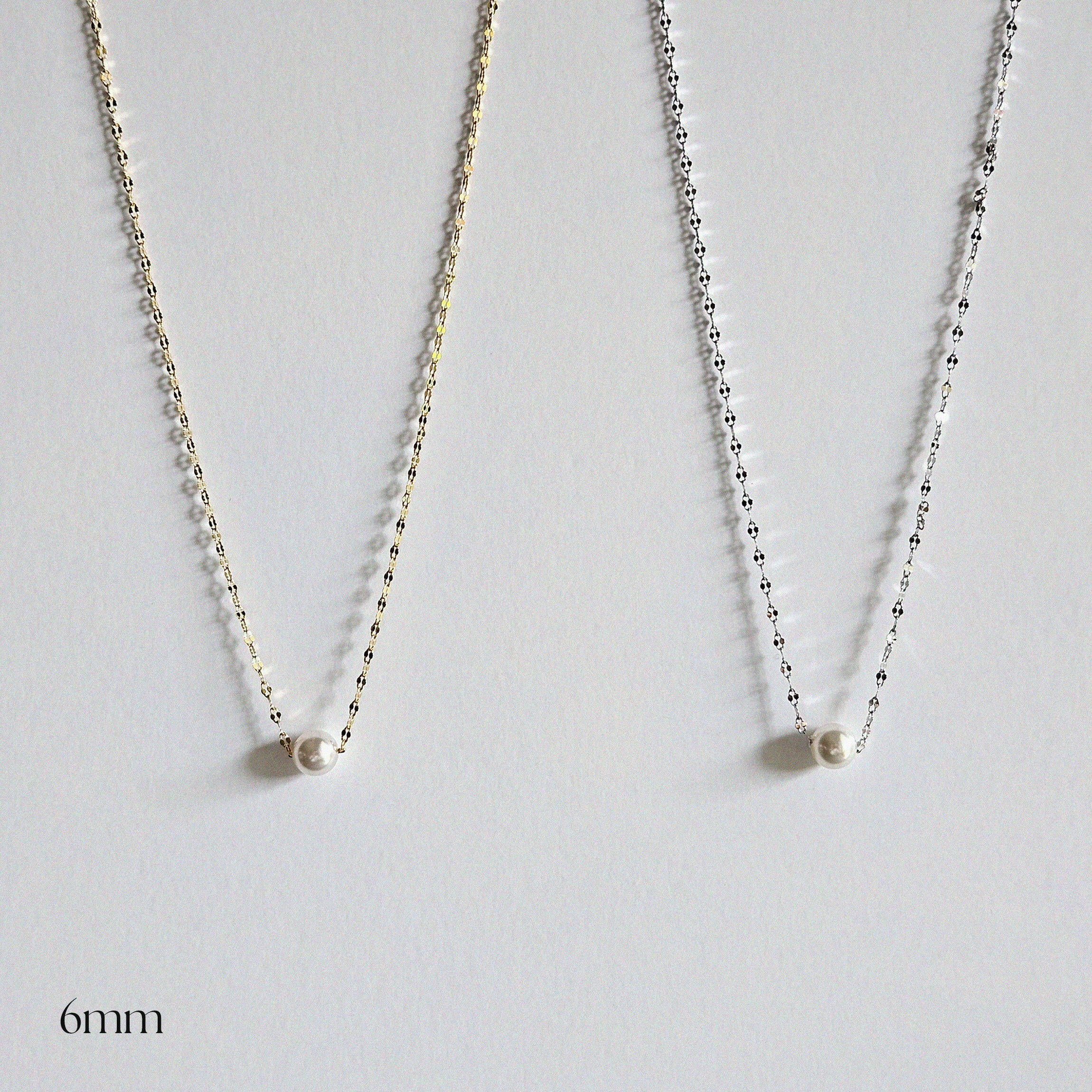 Single pearl necklace exemplifying elegant minimalism, perfect for timeless and sophisticated style.