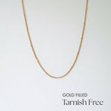 Minimalist gold filled chain necklace laid flat