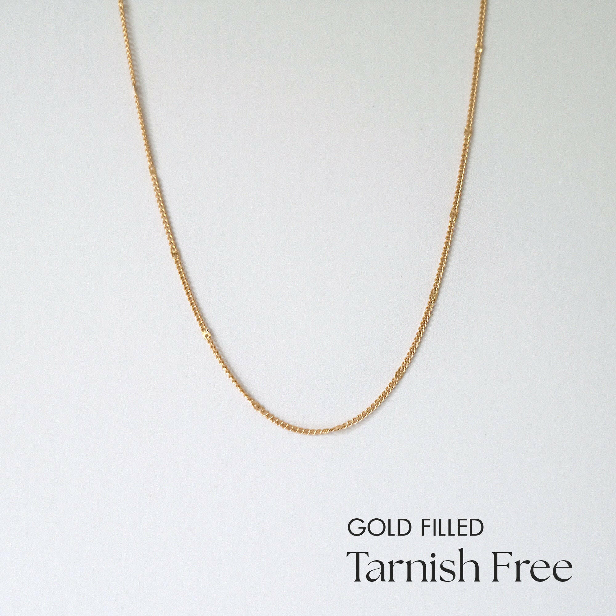 Minimalist gold filled chain necklace laid flat