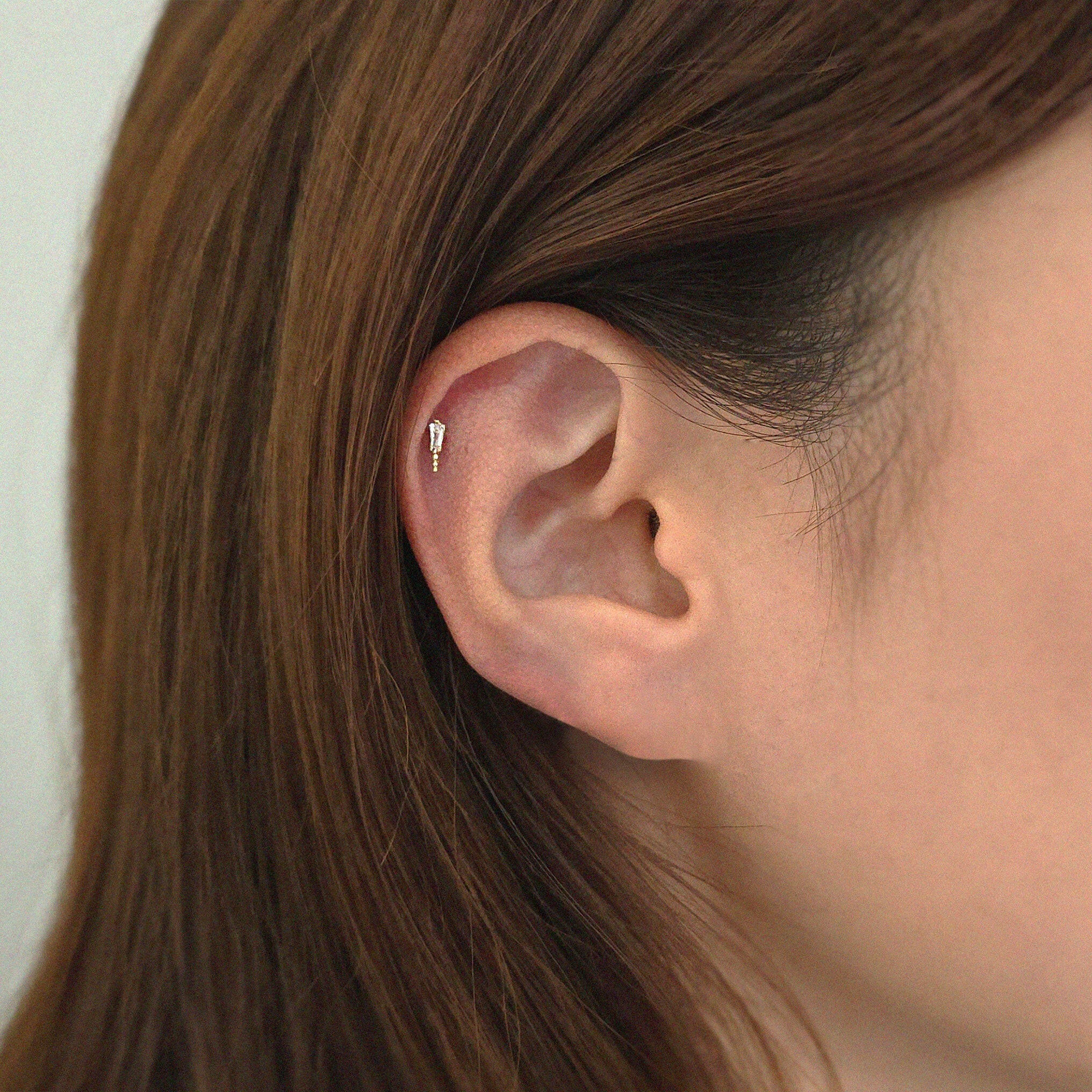14K solid gold Angela Cartilage Earring worn on helix, crystal catching the light