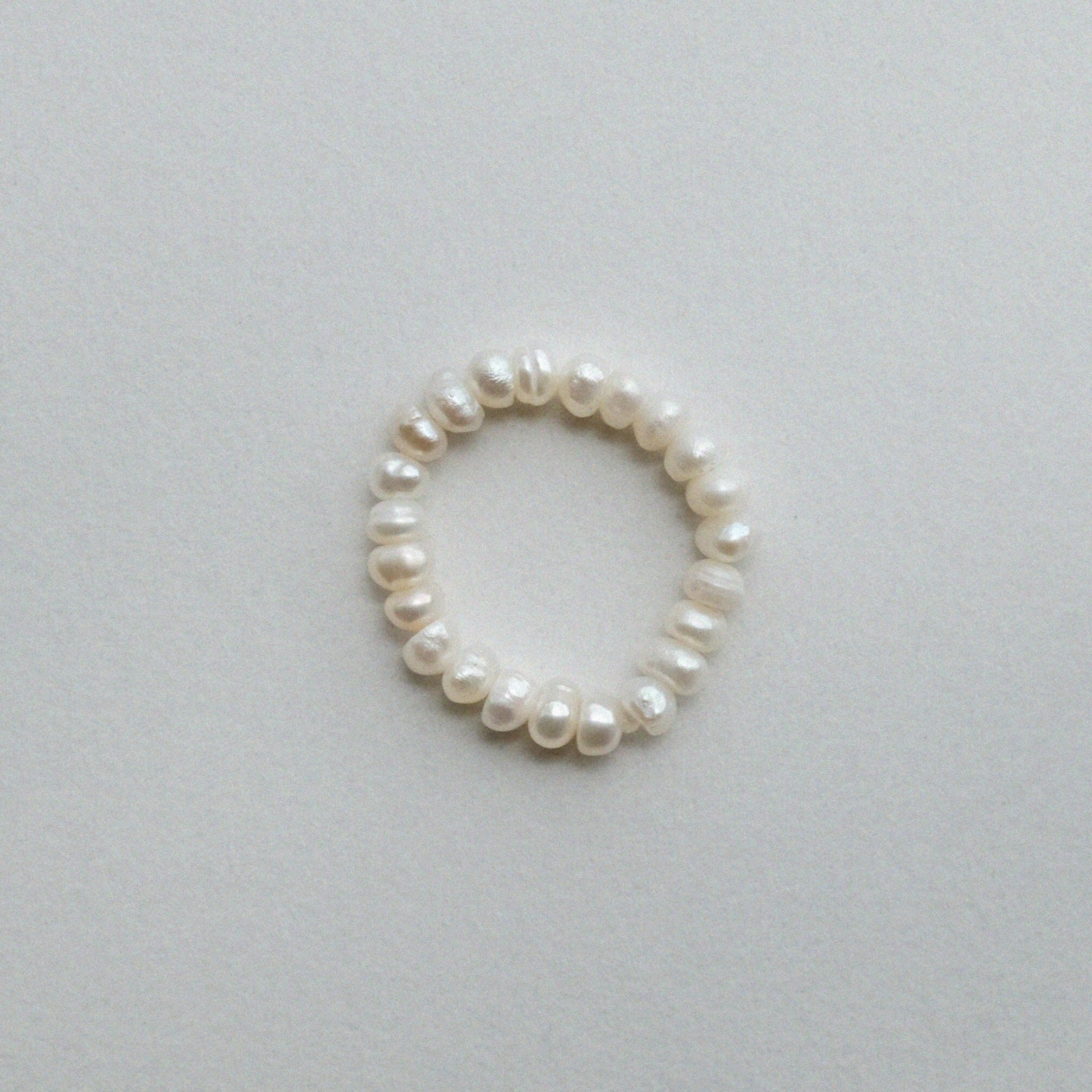 Elegant freshwater pearl beaded stretchy ring showcasing delicate craftsmanship in a stylish beaded design