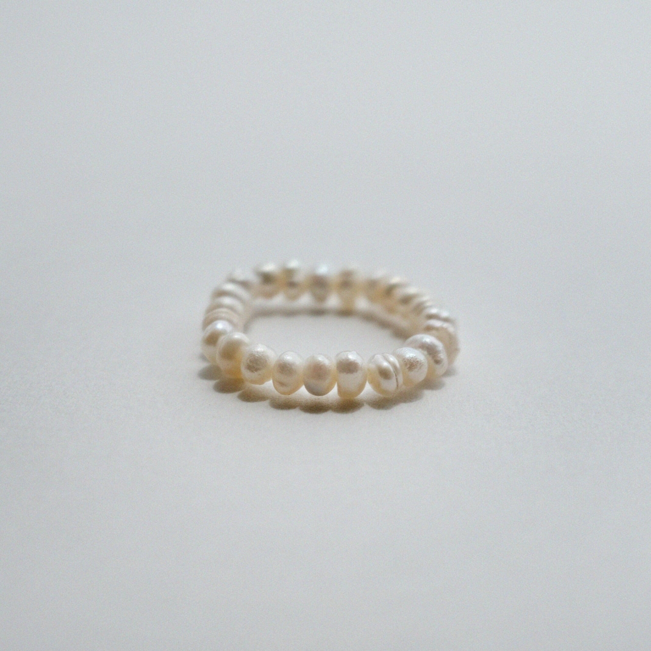 Elegant freshwater pearl beaded stretchy ring showcasing delicate craftsmanship in a stylish beaded design