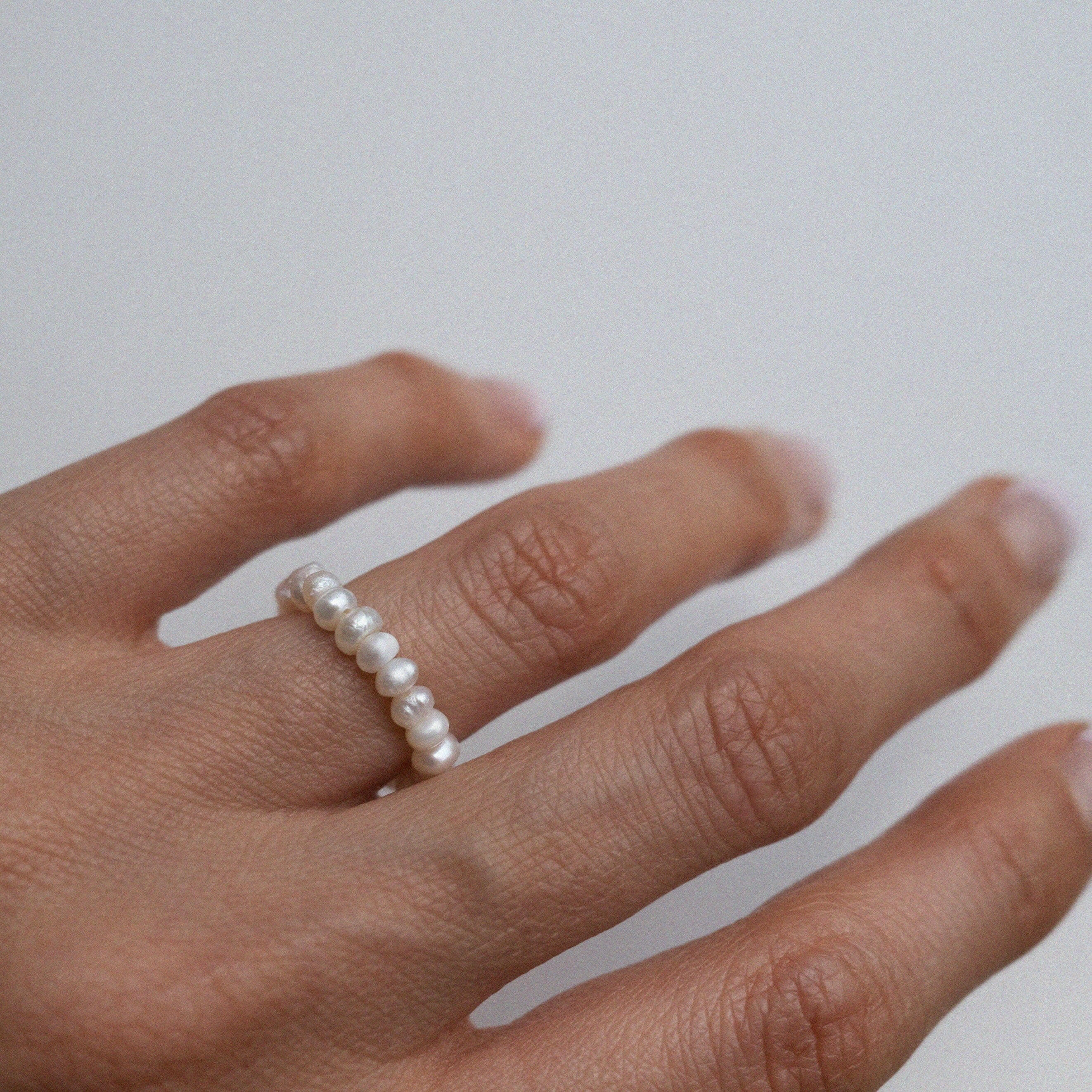 Elegant freshwater pearl beaded stretchy ring showcasing delicate craftsmanship in a stylish beaded design