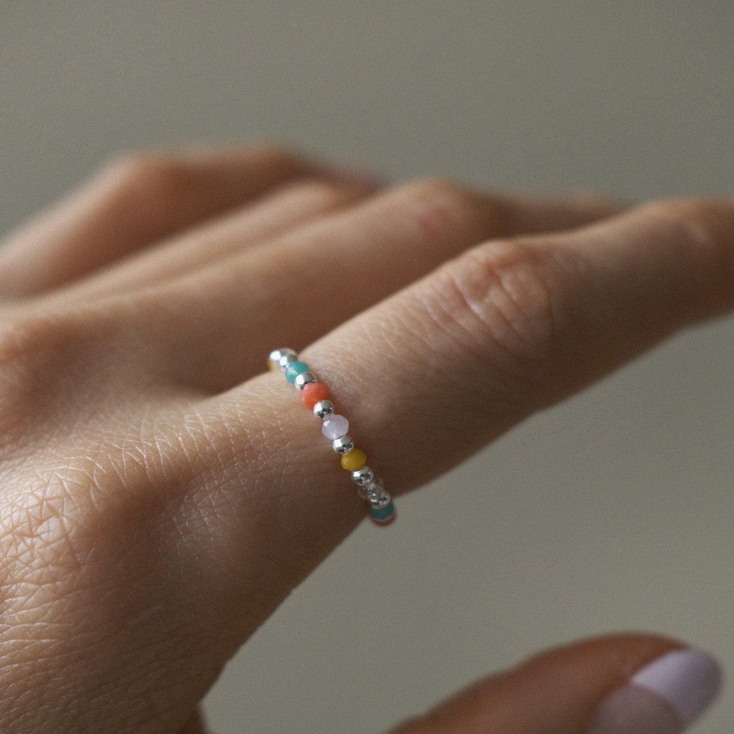 Elegant Bari beads ring with silver bead balls, colorful stones, stretchy design, and handmade craftsmanship