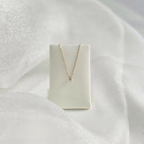 Necklace displayed on white velvet holder – pendant centered in graceful drape