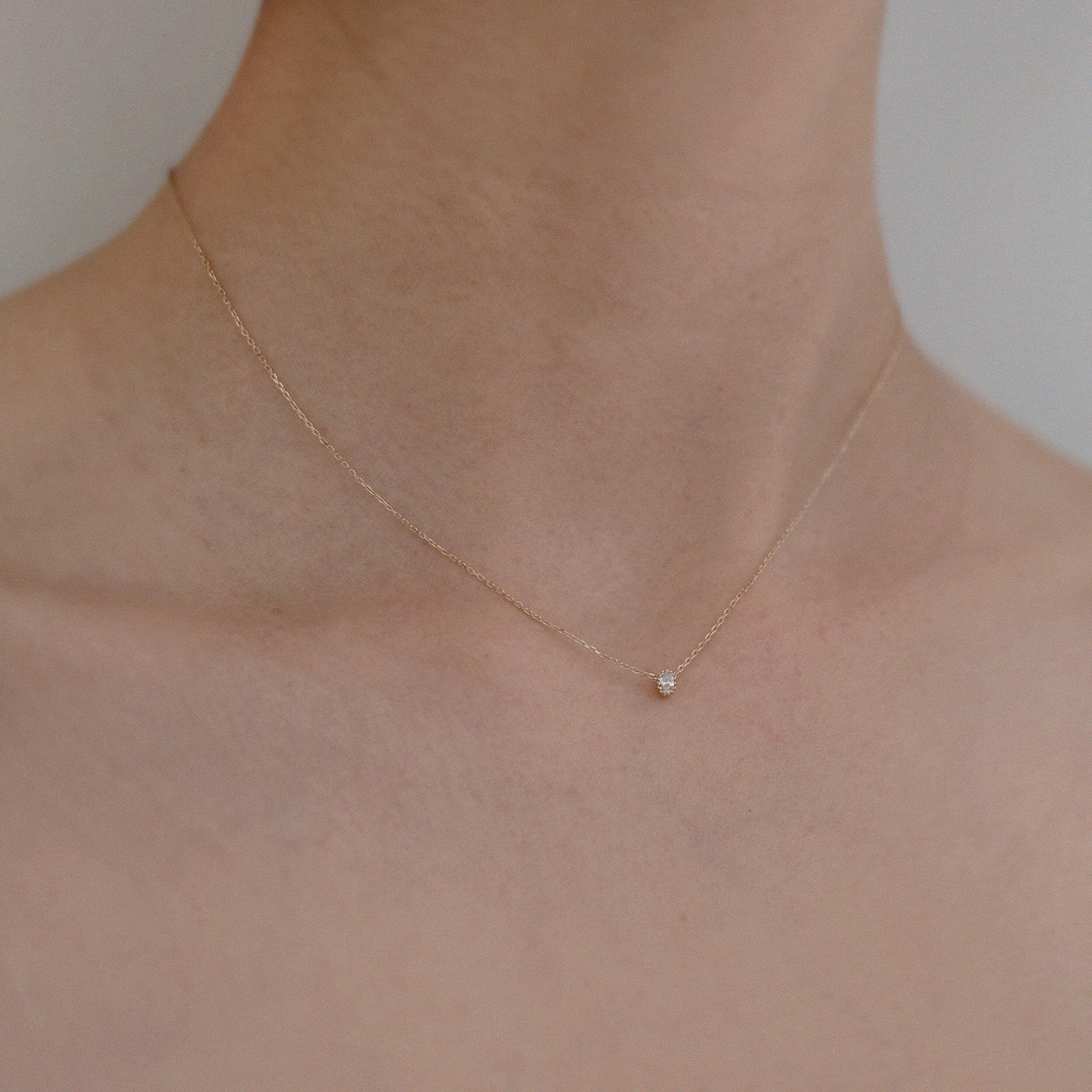 Model wearing Bella Luce Necklace – sparkling zirconia rests near collarbone