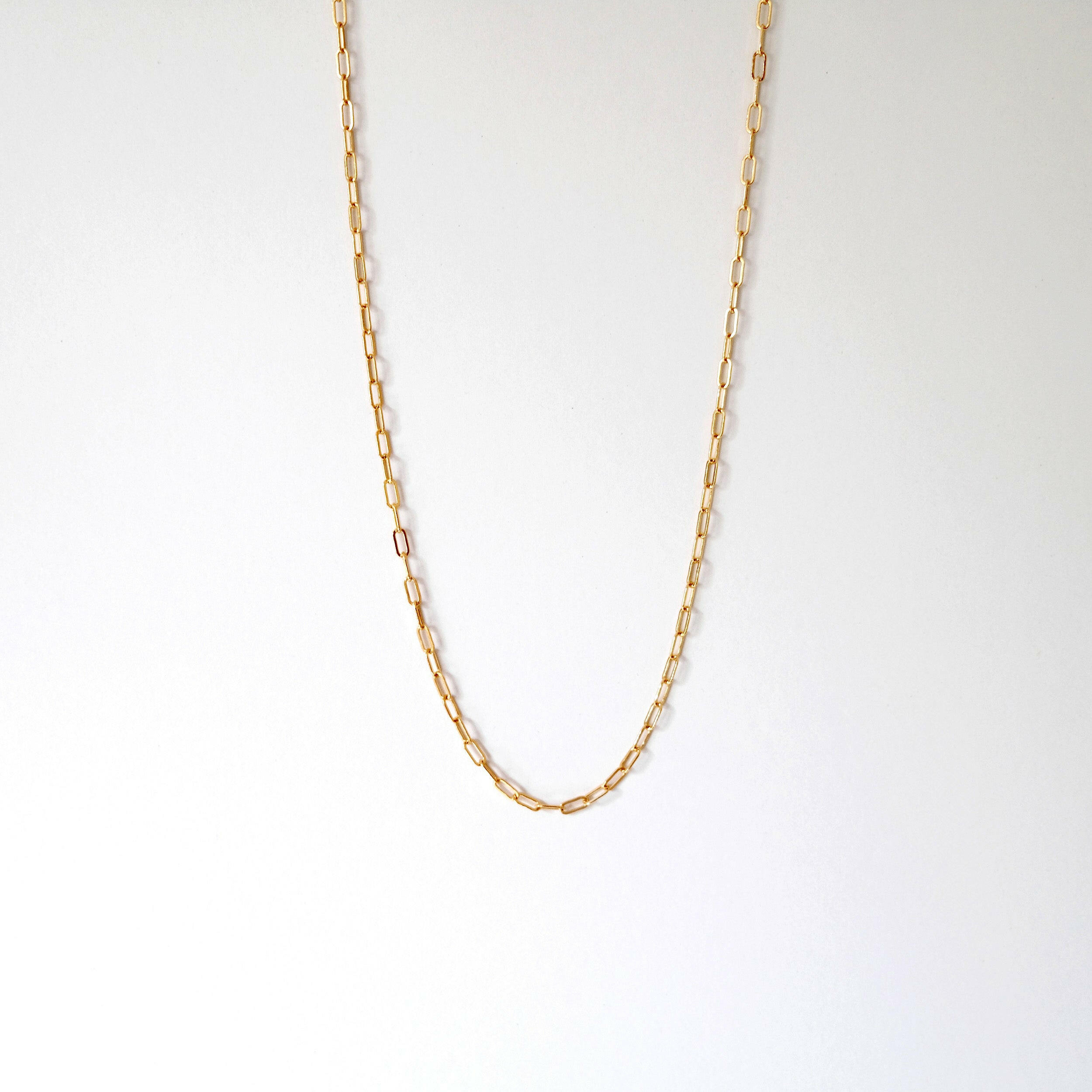 Elongated link gold filled chain necklace laid flat