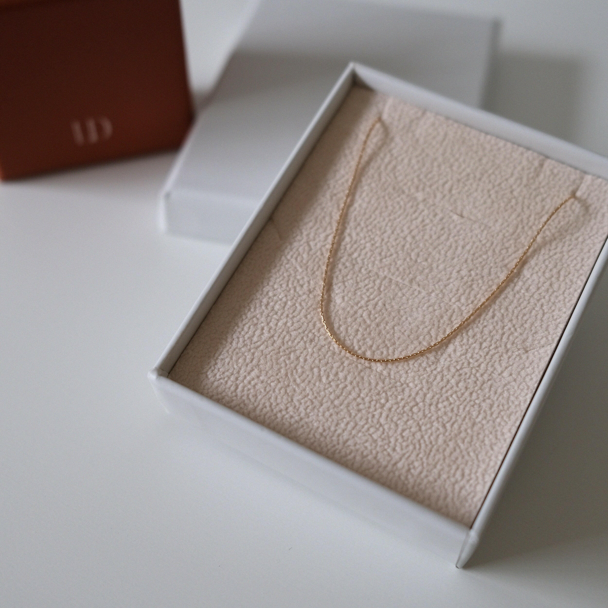 Gold filled cable chain necklace laid flat