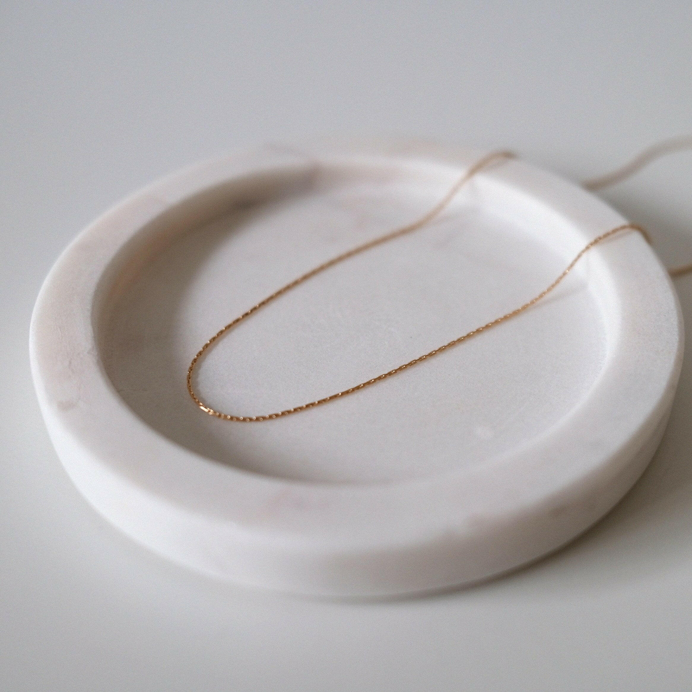 Close-up of smooth cable chain links with gentle shine