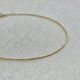 Macro view highlighting the sculptural curve of the gold chain