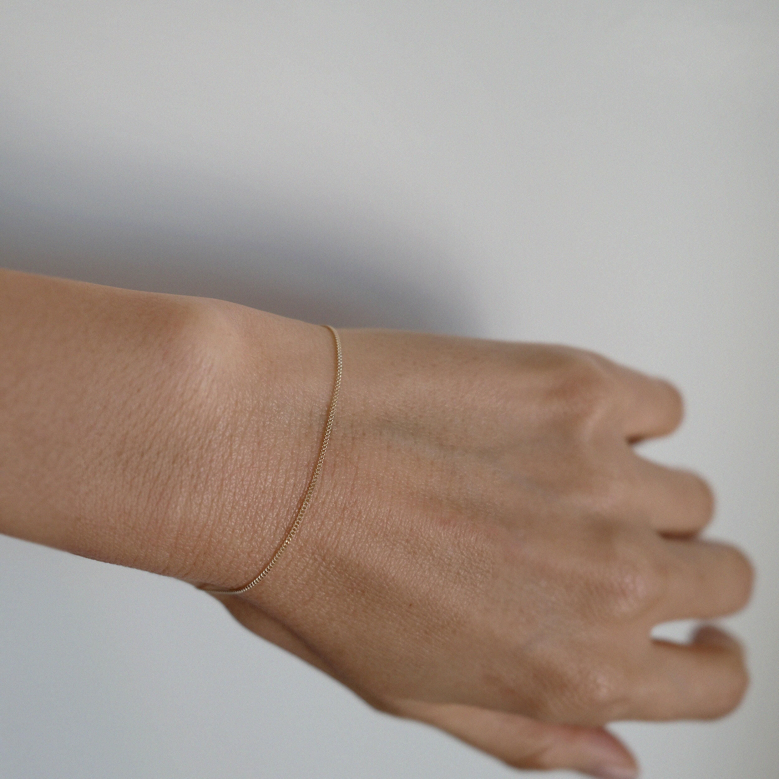 14K gold bracelet with modern curved design styled for everyday elegance