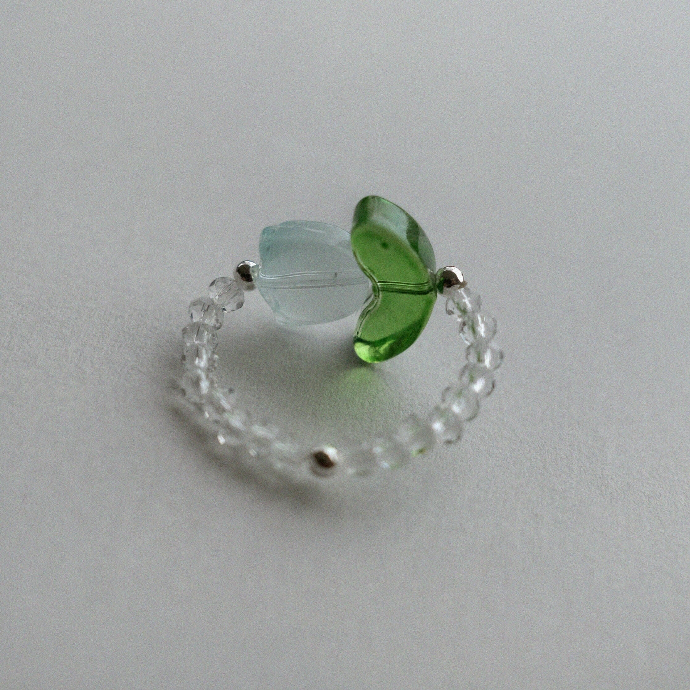 Handmade floral beaded ring featuring tulip flower centerpiece, and clear stones for elegant style