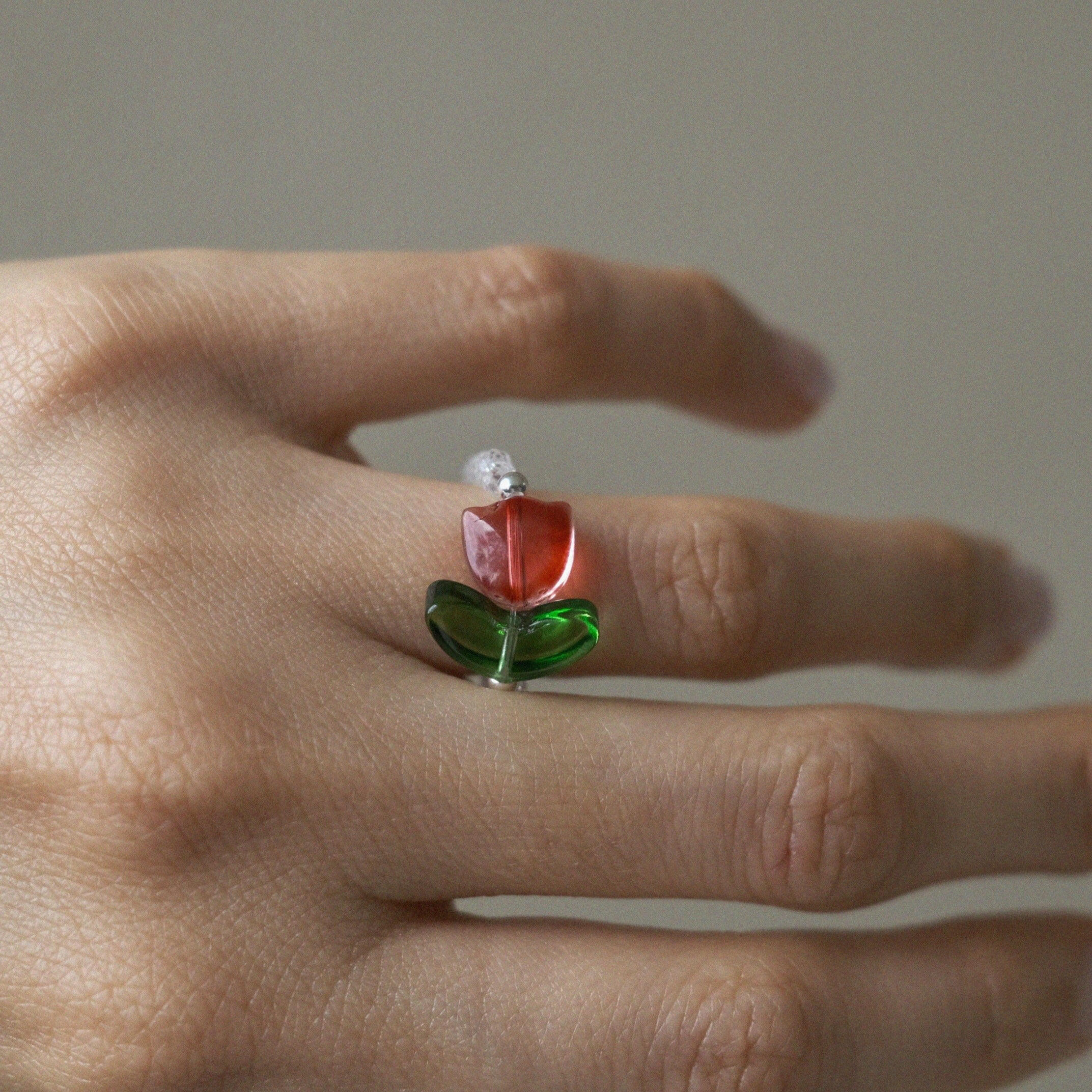 Handmade floral beaded ring featuring tulip flower centerpiece, and clear stones for elegant style