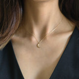 Model wearing Crescent Luna Necklace with minimalist gold moon pendant for subtle elegance