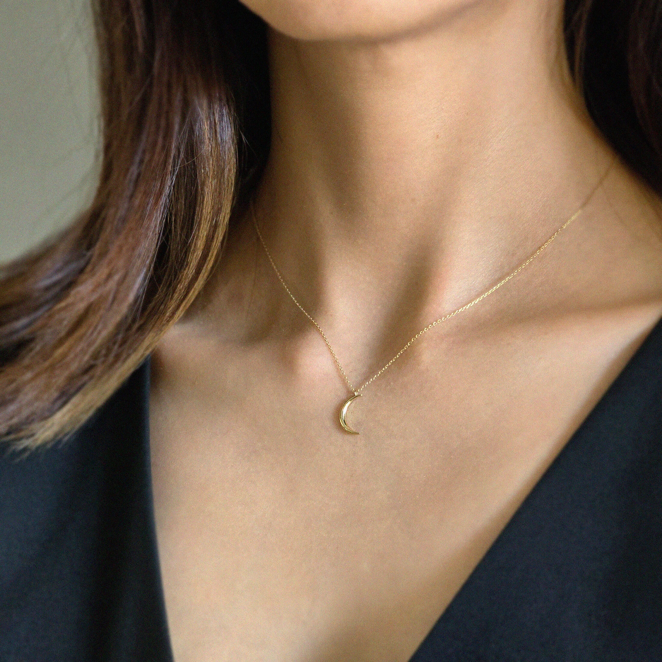 Model wearing Crescent Luna Necklace with minimalist gold moon pendant for subtle elegance
