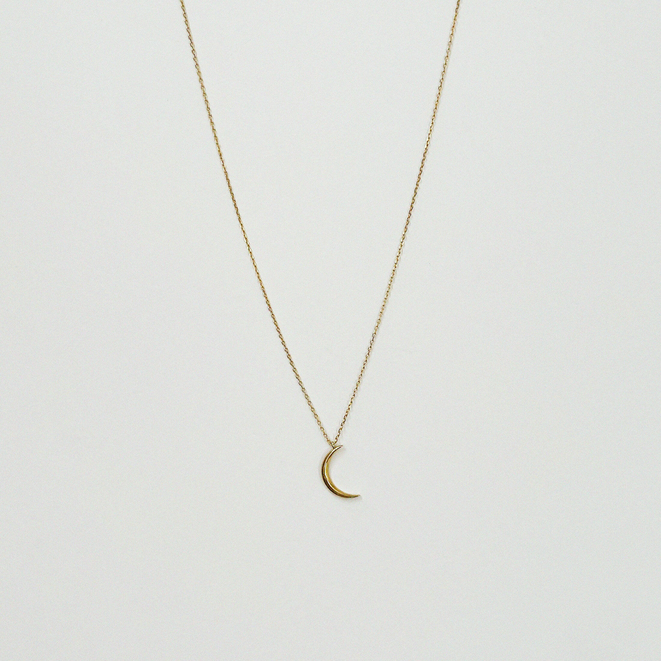 14K Solid Gold Crescent Luna Necklace featuring a delicate moon pendant on sparkling chain