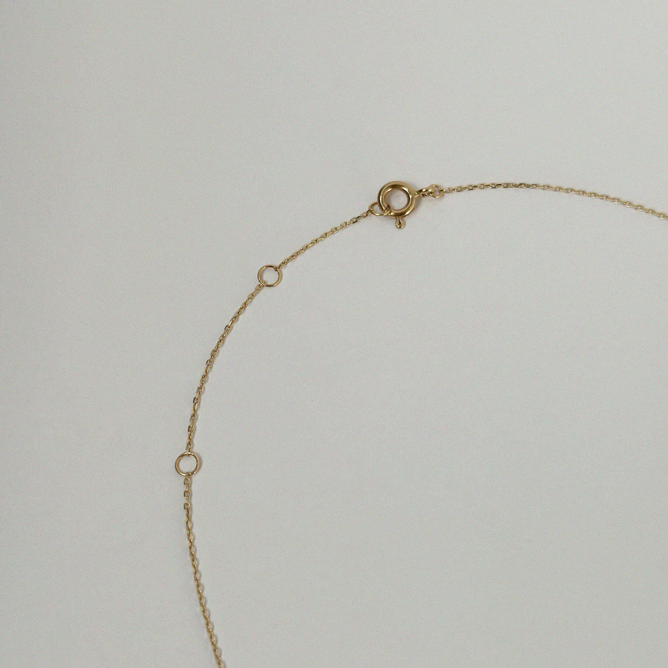 Detail view of dainty gold chain with secure clasp and smooth link structure on Crescent Luna Necklace