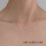 Close-up of model’s neckline wearing Laondrim 14K gold necklace, subtle sparkle of cubic zirconia visible against skin