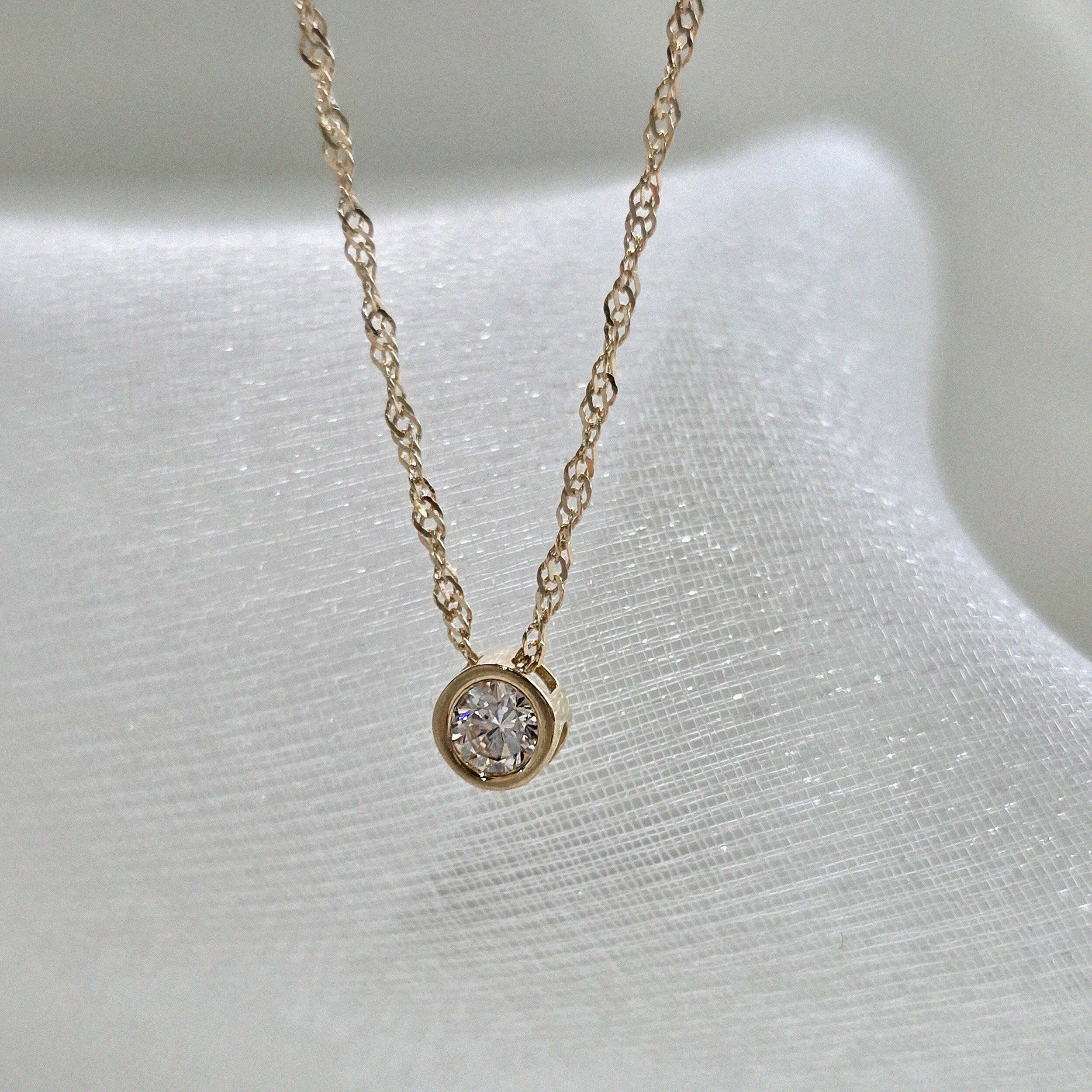 14K solid gold crystal accent necklace, top view showing cubic zirconia sparkle